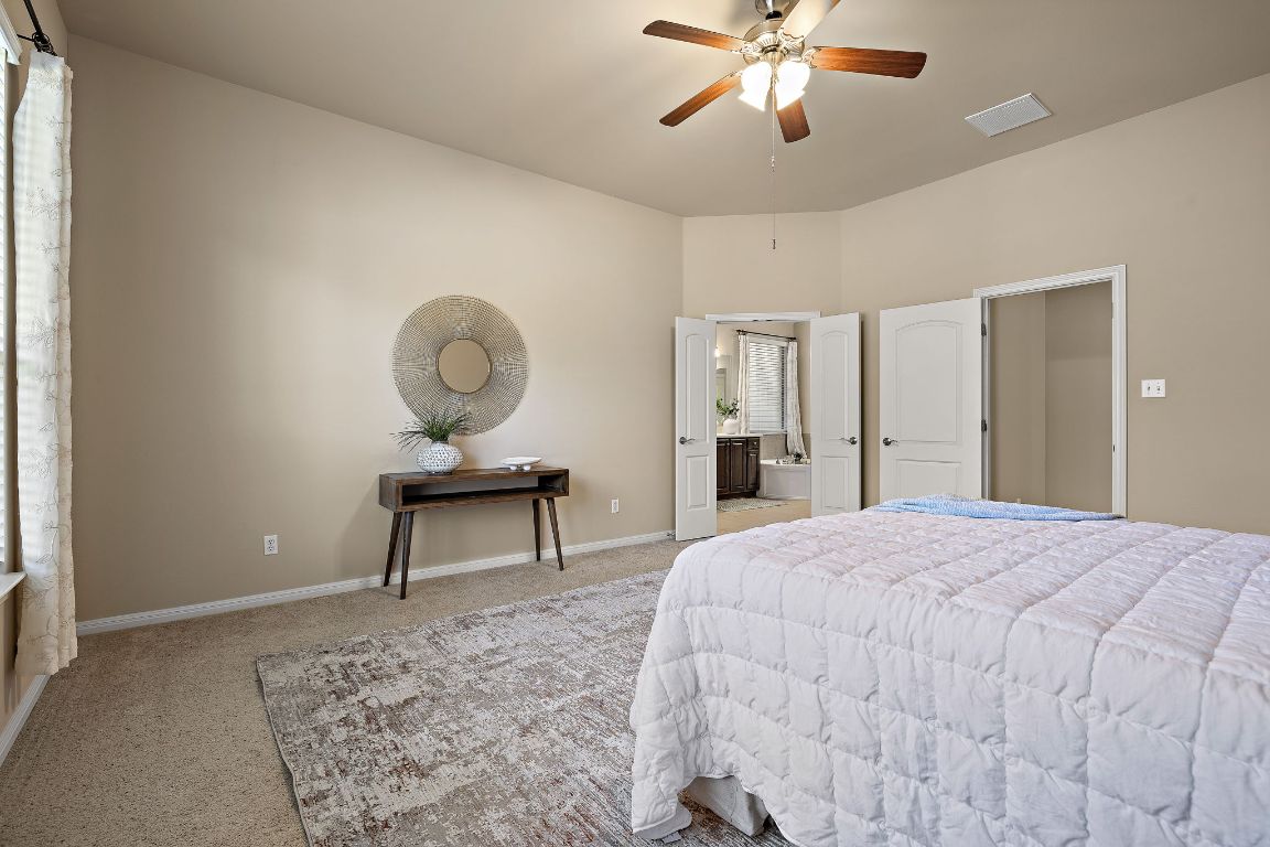 3948 Sapphire Loop Round Rock, TX 78681 - Photo 22 of 40 a bedroom with a bed and a chandelier