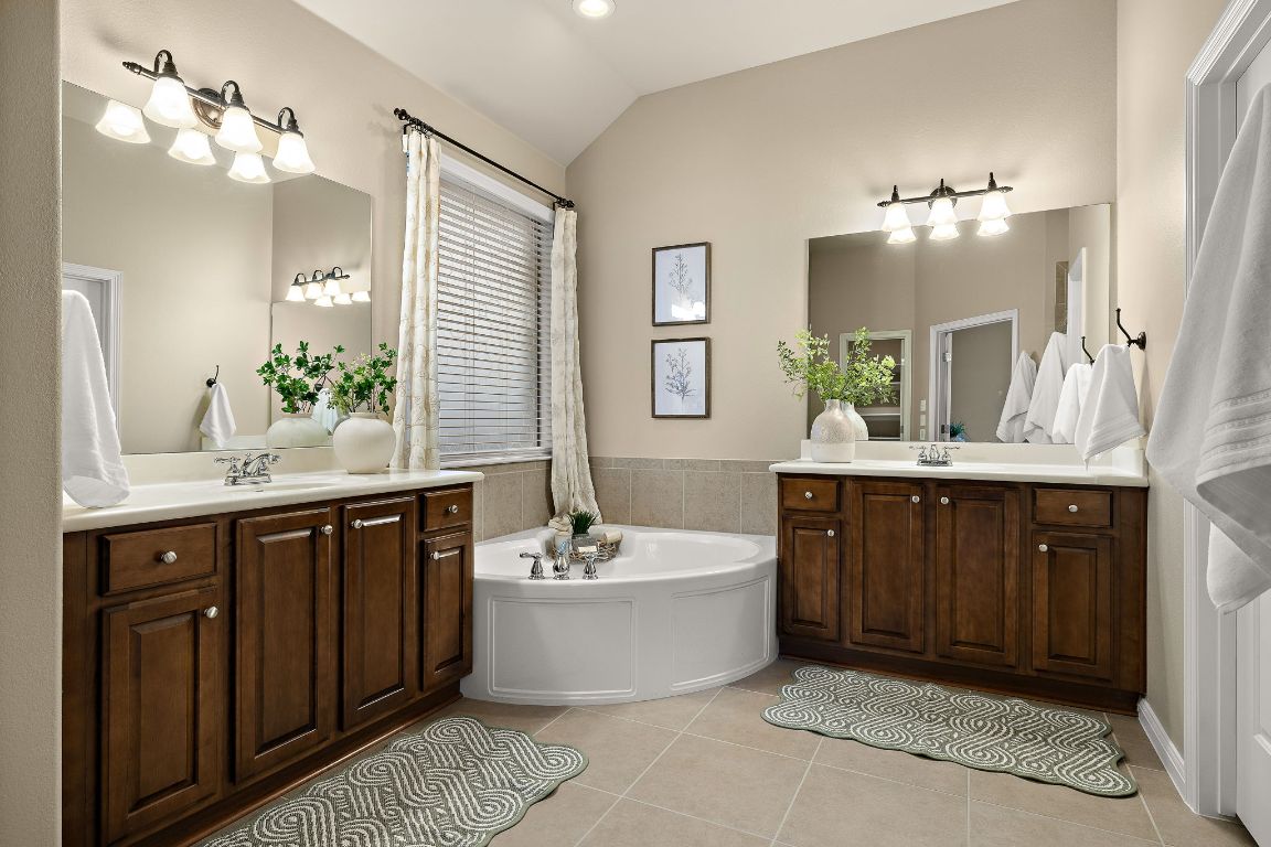 3948 Sapphire Loop Round Rock, TX 78681 - Photo 23 of 40 a spacious bathroom with a tub double sink and mirror