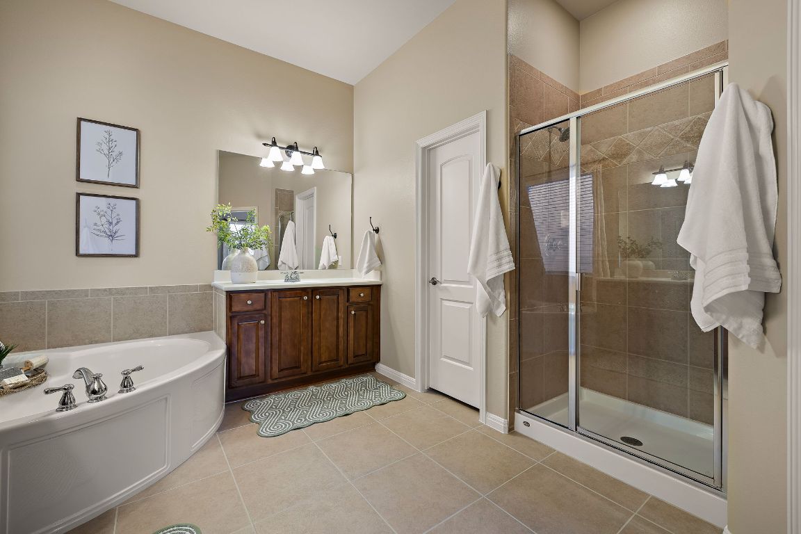3948 Sapphire Loop Round Rock, TX 78681 - Photo 24 of 40 a bathroom with a tub sink and mirror