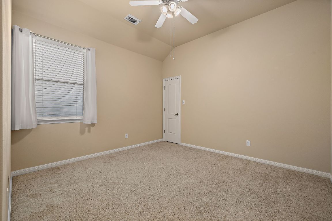 3948 Sapphire Loop Round Rock, TX 78681 - Photo 28 of 40 an empty room with a window and a fan