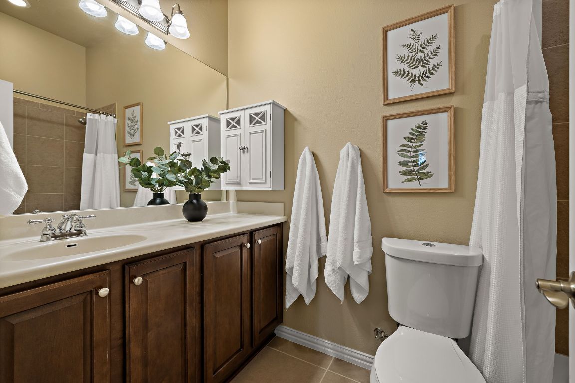 3948 Sapphire Loop Round Rock, TX 78681 - Photo 29 of 40 a bathroom with a toilet sink and mirror