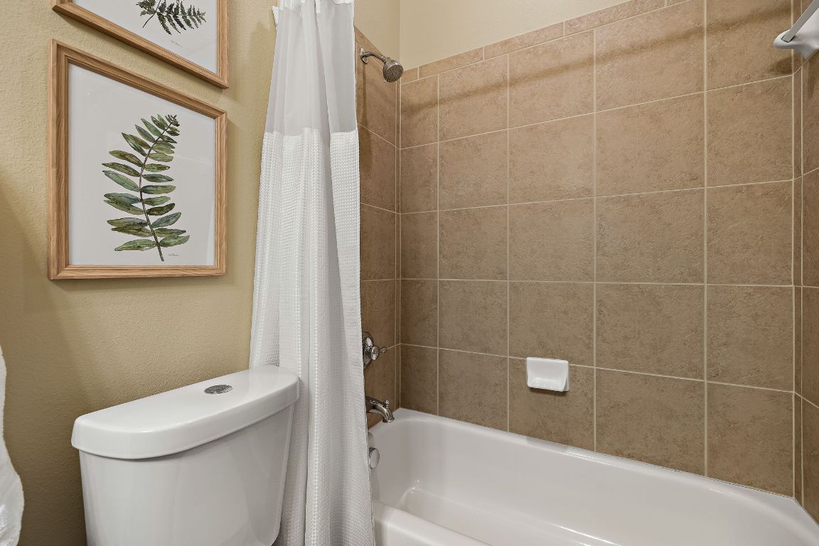 3948 Sapphire Loop Round Rock, TX 78681 - Photo 30 of 40 a bathroom with a toilet and a tub