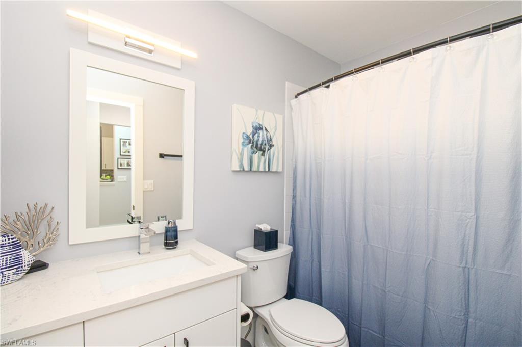 225 Robin Hood Circle, Unit 203 Naples, FL 34104 - Photo 31 of 50 Bathroom with vanity and toilet