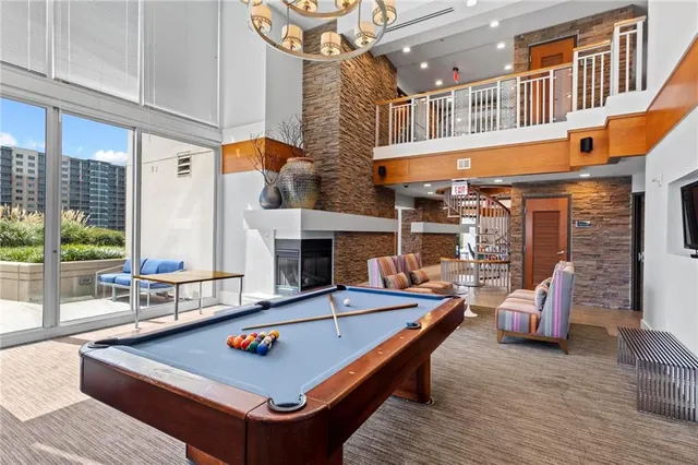 a living room with fireplace furniture and a large window