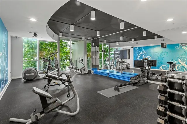 a room with gym equipment and a large window
