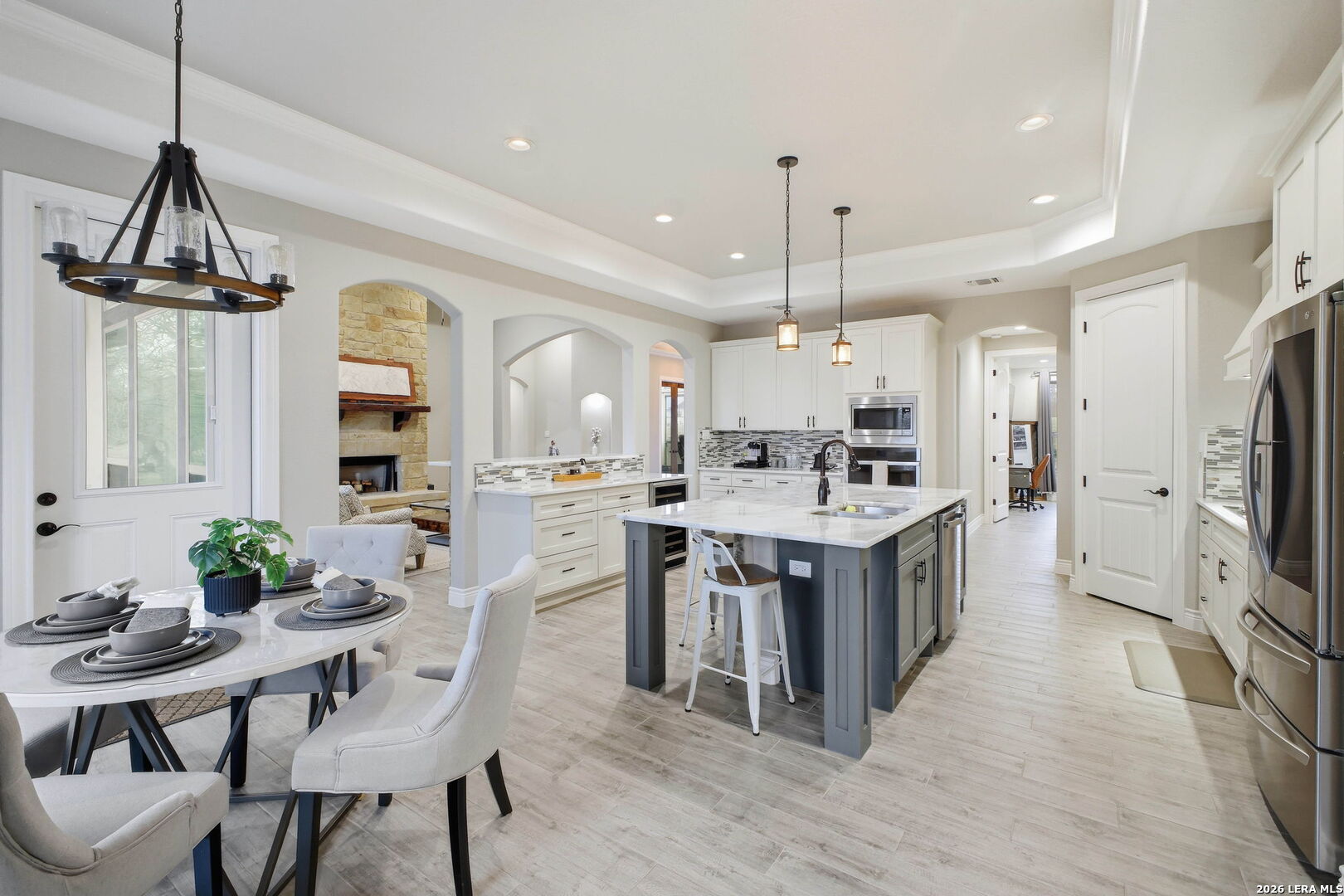 117 Crescent Ridge Adkins, TX 78101 - Photo 18 of 49 a kitchen with stainless steel appliances kitchen island a dining table chairs and a refrigerator
