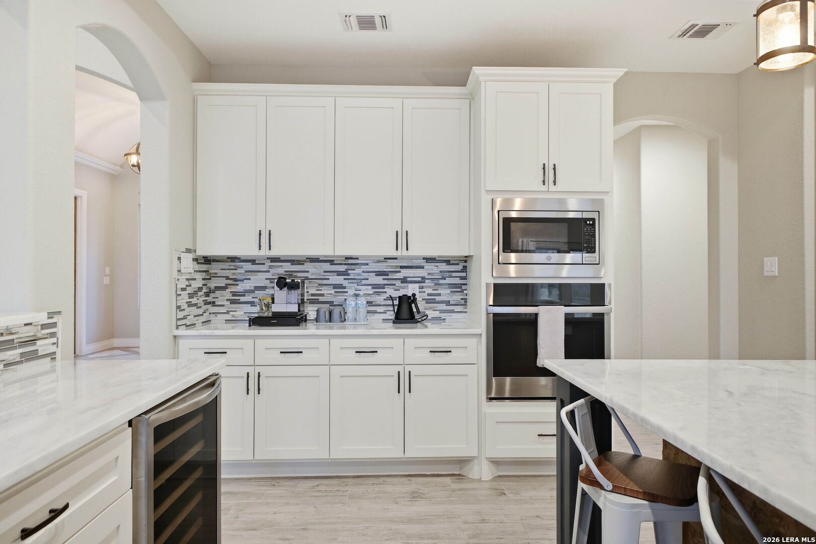 117 Crescent Ridge Adkins, TX 78101 - Photo 21 of 49 a kitchen with stainless steel appliances a stove a sink island and a refrigerator