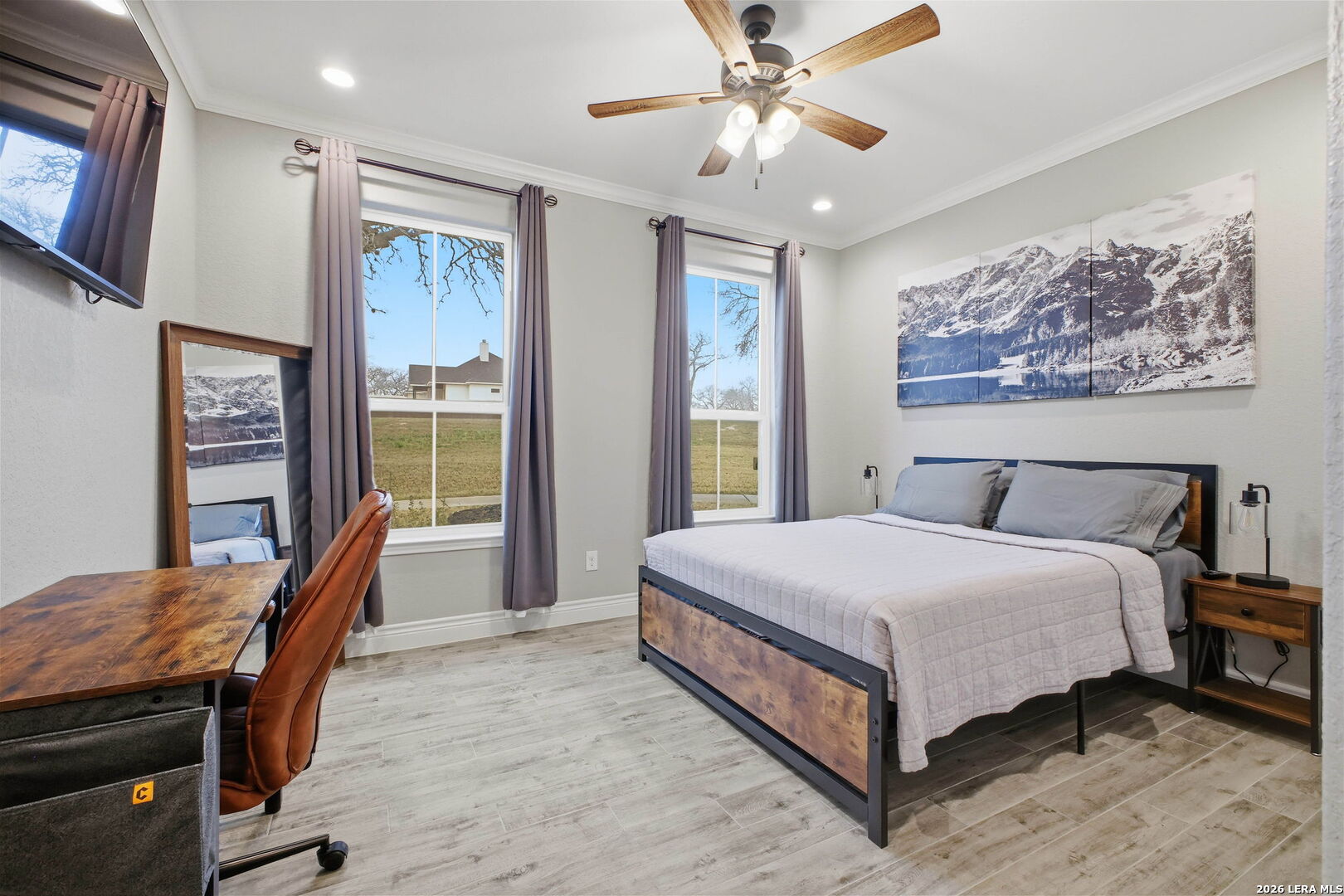 117 Crescent Ridge Adkins, TX 78101 - Photo 35 of 49 a bedroom with a large bed a chandelier and dresser