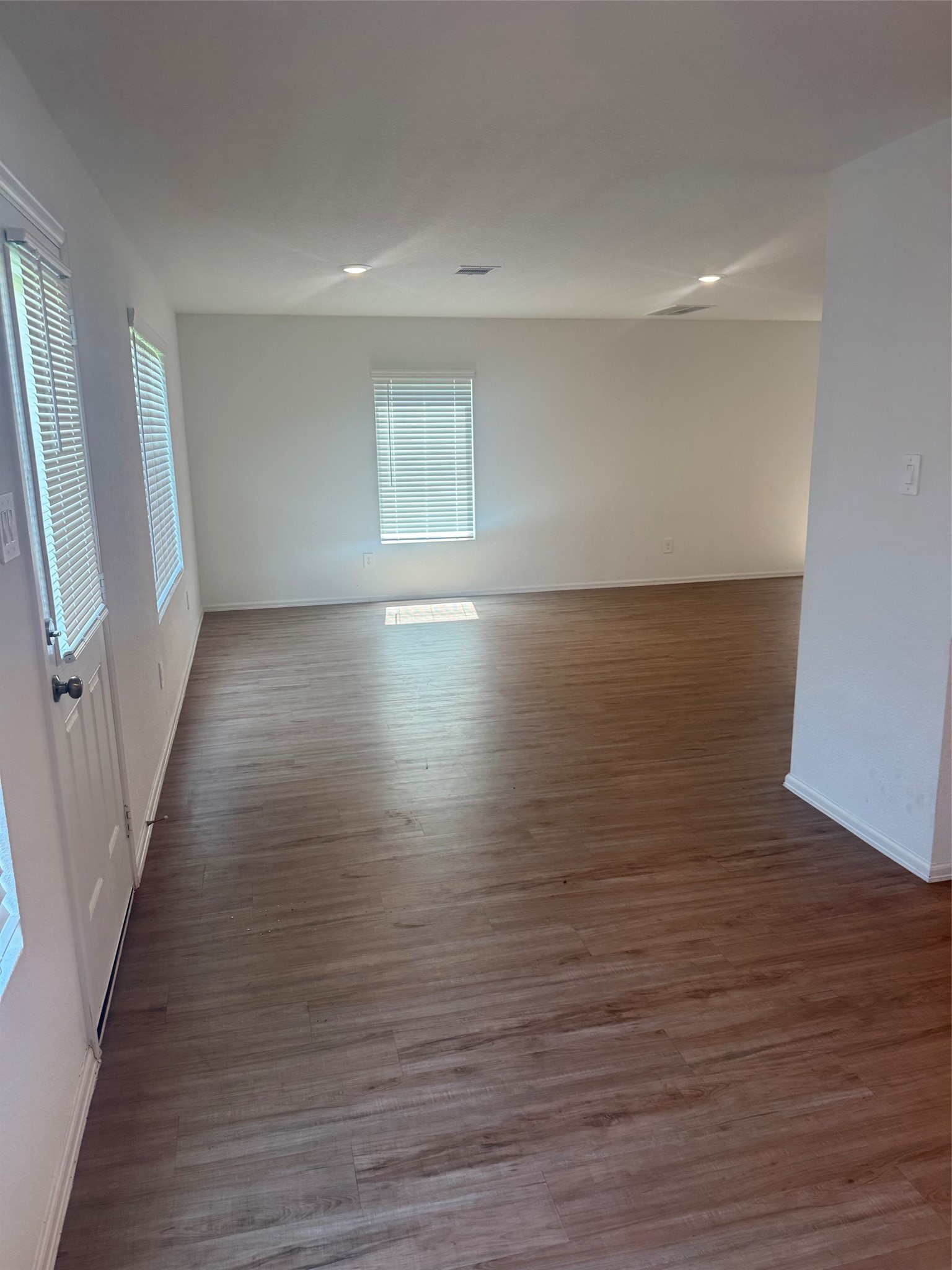 3202 Holly Stokes Way Conroe, TX 77301 - Photo 9 of 24 wooden floor in an empty room with a window
