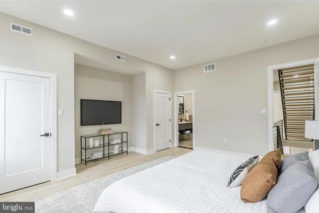 a bedroom with a bed and a flat screen tv