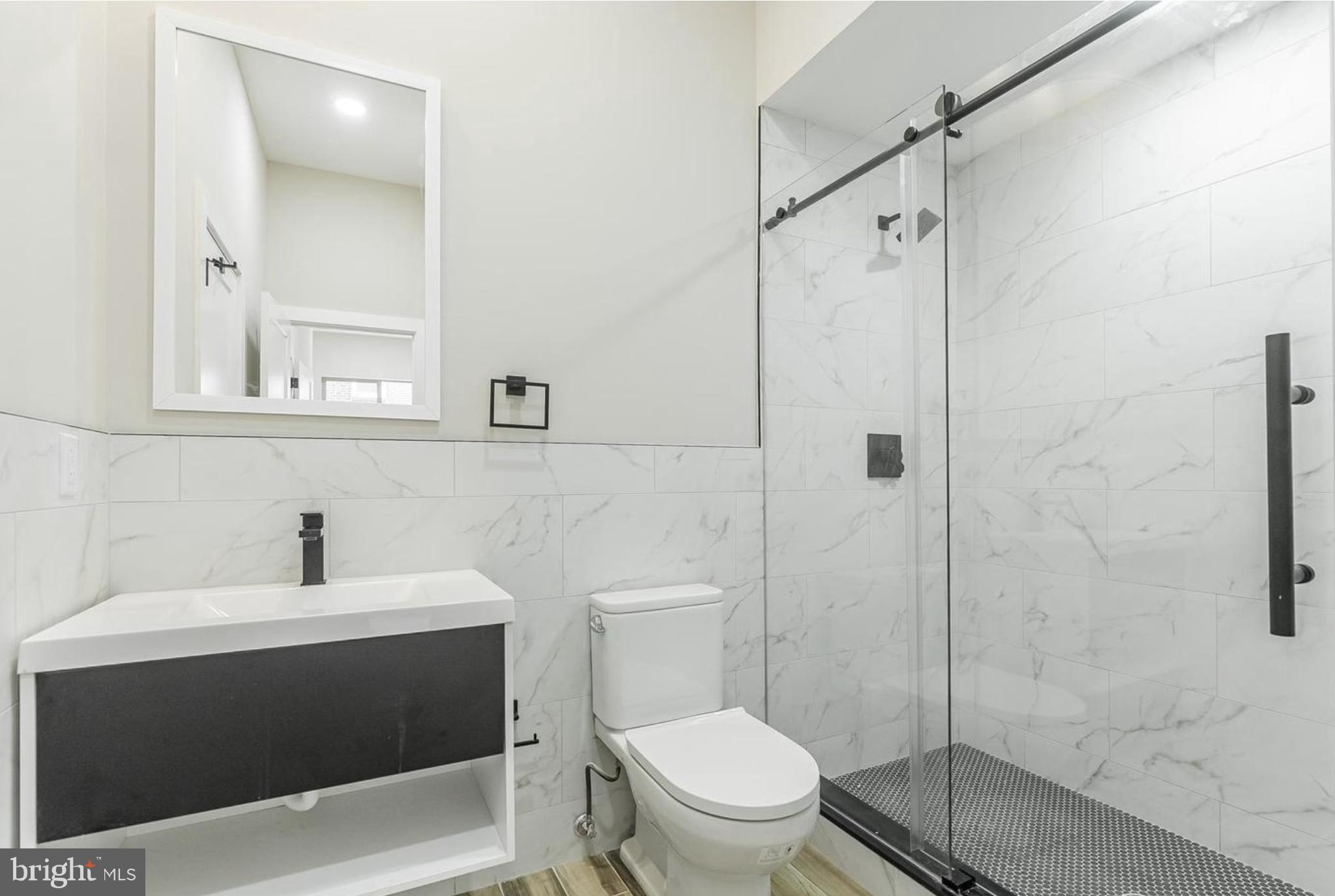 3223-29 Mercer Street Philadelphia, PA 19134 - Photo 17 of 25 a bathroom with a sink a toilet and shower