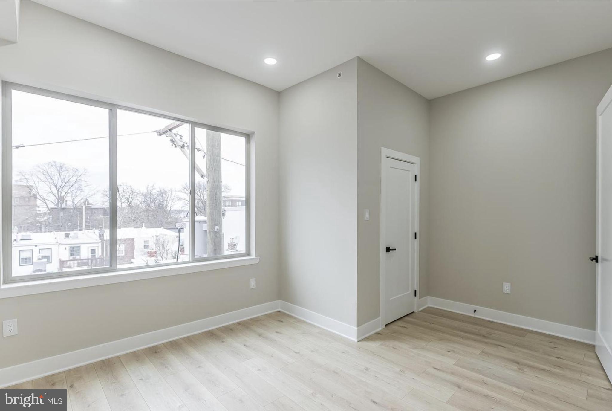 3223-29 Mercer Street Philadelphia, PA 19134 - Photo 18 of 25 a view of an empty room with wooden floor and a window