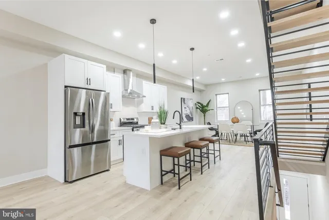 a large kitchen with a table and chairs