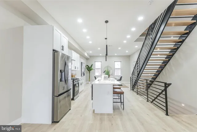 a view of a kitchen with furniture and a wooden floor