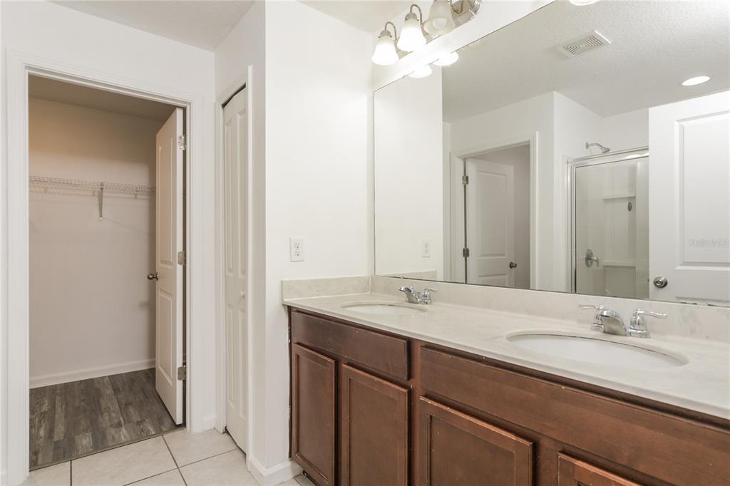 1477 Lucerne Loop Road Northeast Winter Haven, FL 33881 - Photo 11 of 15 a bathroom with a granite countertop sink and a mirror