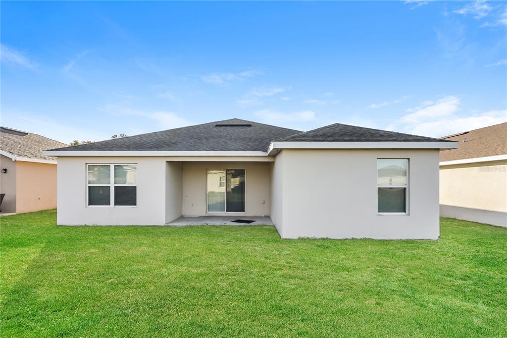 1477 Lucerne Loop Road Northeast Winter Haven, FL 33881 - Photo 15 of 15 front view of house with a yard