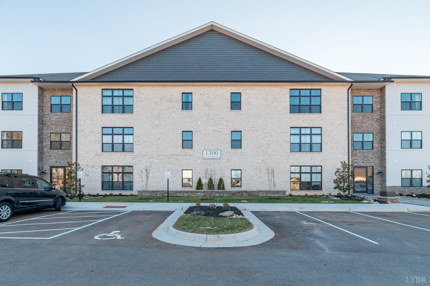 1300 Stoney Ridge Boulevard, Unit 101 Forest, VA 24551 - Photo 1 of 18 a front view of a house with a yard