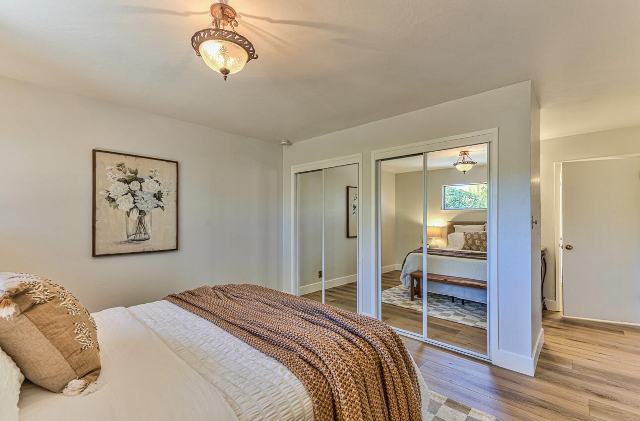 242 Howes Drive Los Gatos, CA 95032 - Photo 21 of 37 a bedroom with a bed and a chandelier