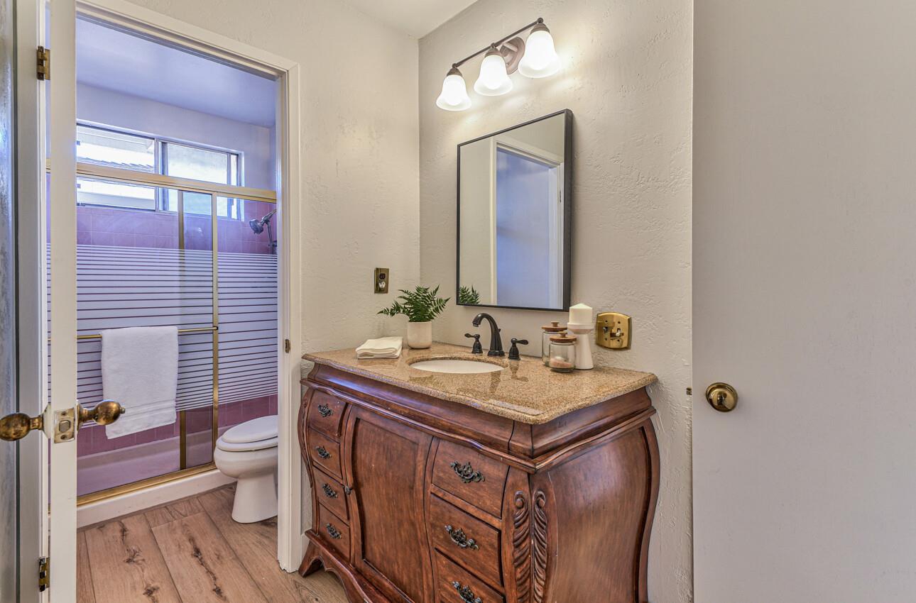 242 Howes Drive Los Gatos, CA 95032 - Photo 23 of 37 a bathroom with a sink a toilet and a mirror