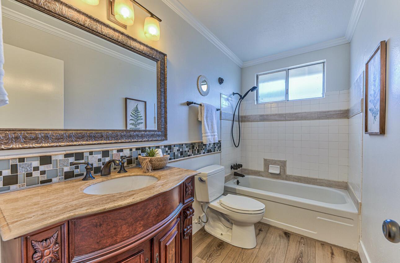 242 Howes Drive Los Gatos, CA 95032 - Photo 30 of 37 a bathroom with a granite countertop toilet a sink and a bathtub