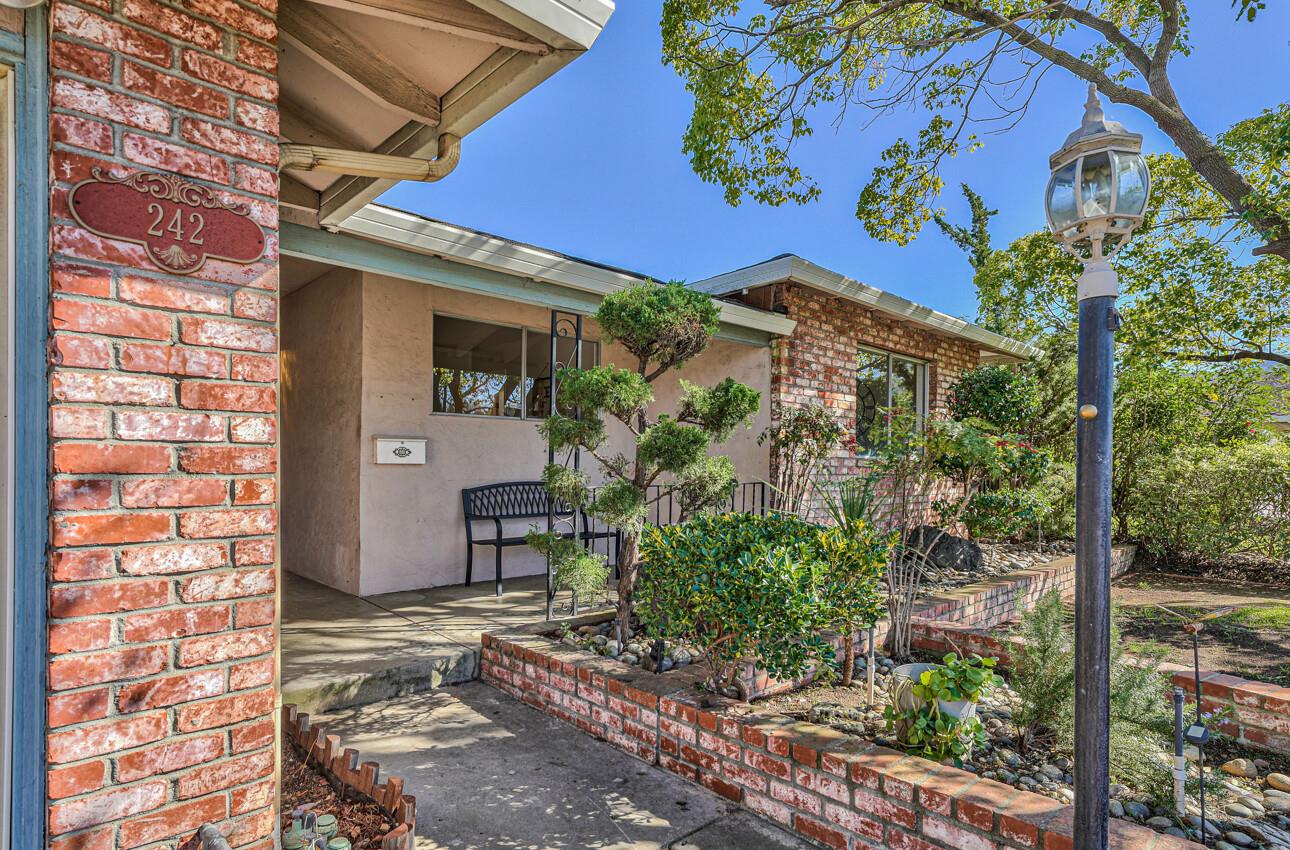 242 Howes Drive Los Gatos, CA 95032 - Photo 3 of 37 a view of a house with a tree and plants