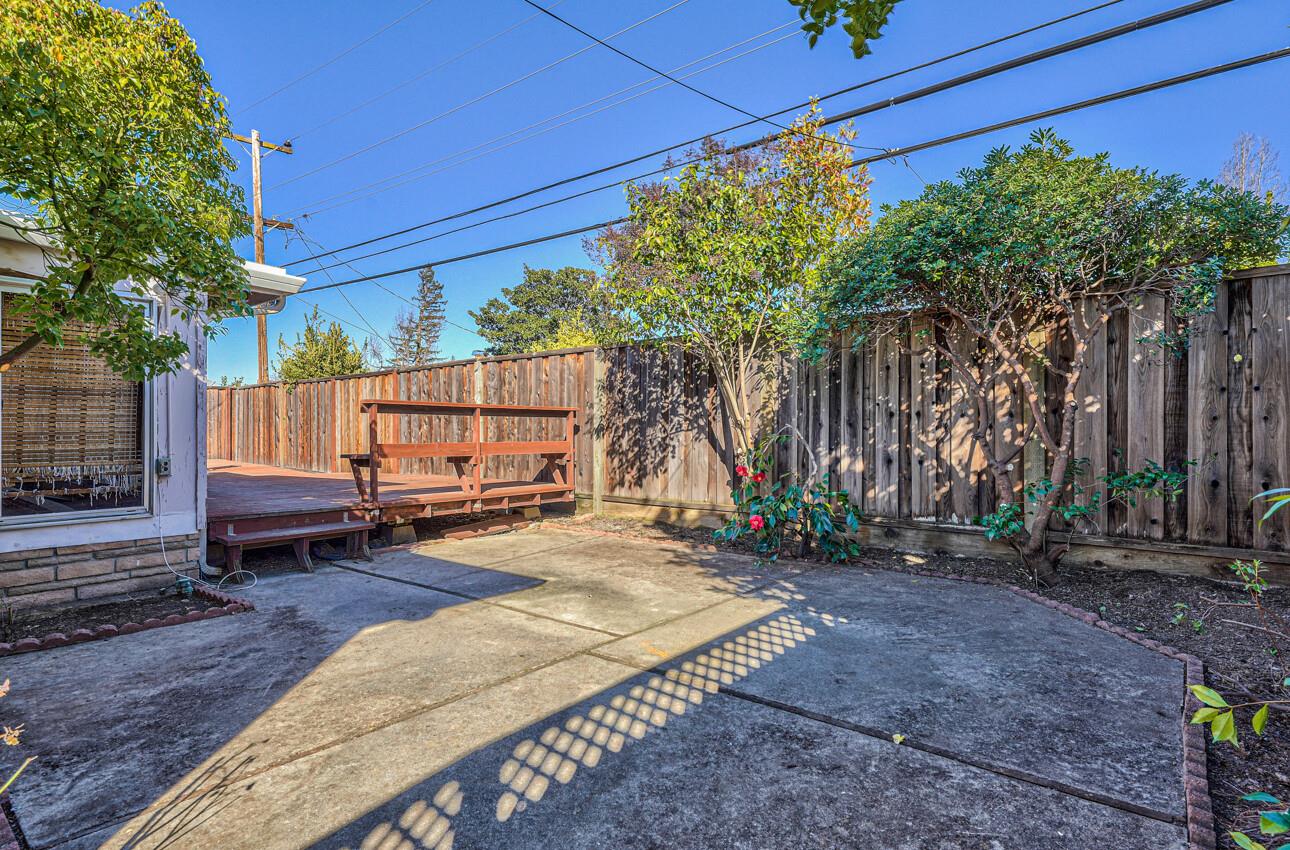 242 Howes Drive Los Gatos, CA 95032 - Photo 34 of 37 a view of backyard with a table and chairs and a large tree