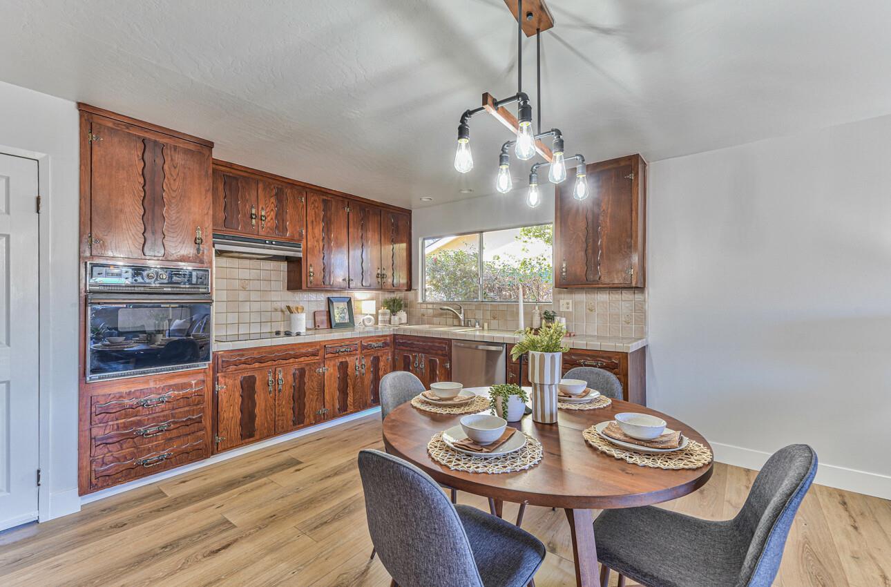 242 Howes Drive Los Gatos, CA 95032 - Photo 10 of 37 a dining room with furniture a window and wooden floor