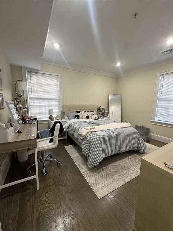 56 Cedar Street, Unit 2 Boston, MA 02119 - Photo 12 of 16 a bedroom with a bed a desk and chair