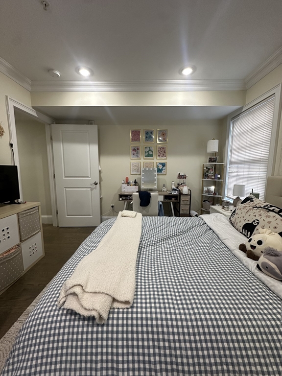 56 Cedar Street, Unit 2 Boston, MA 02119 - Photo 14 of 16 a bed room with a bed and a view of kitchen