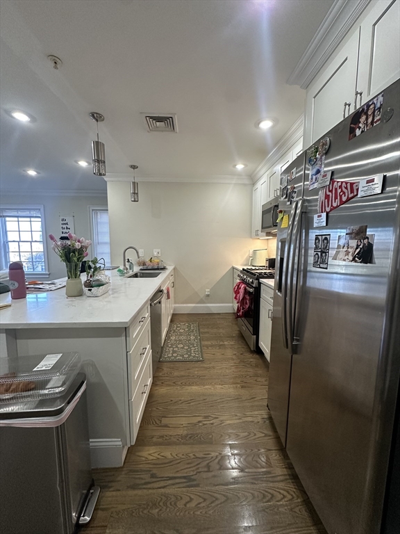 56 Cedar Street, Unit 2 Boston, MA 02119 - Photo 3 of 16 a kitchen with a sink and refrigerator