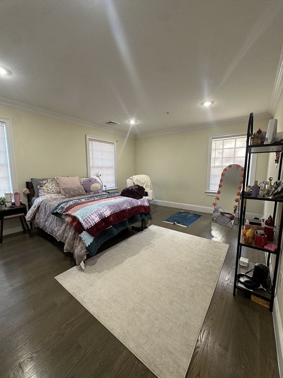 56 Cedar Street, Unit 2 Boston, MA 02119 - Photo 4 of 16 a bedroom with a bed and wooden floor