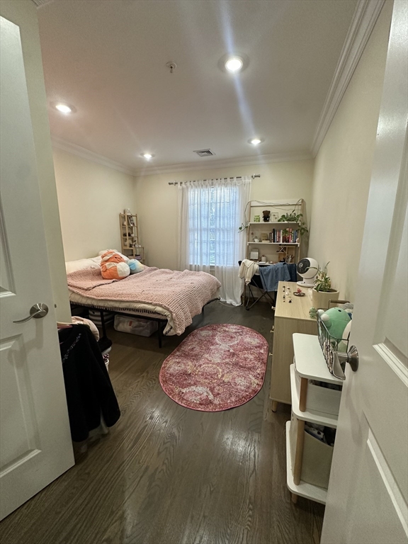 56 Cedar Street, Unit 2 Boston, MA 02119 - Photo 9 of 16 a bedroom with furniture and a wooden floor