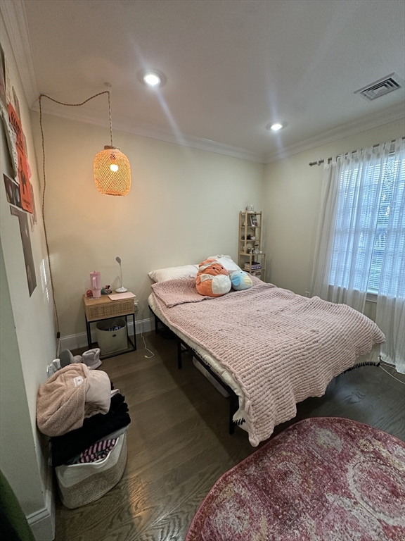 56 Cedar Street, Unit 2 Boston, MA 02119 - Photo 10 of 16 a bedroom with a bed and wooden floor