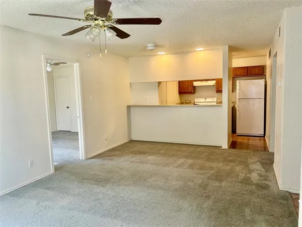 a view of a livingroom with a kitchen