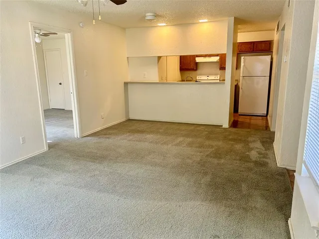 a view of kitchen appliances with wooden floor