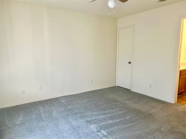 an empty room with a ceiling fan