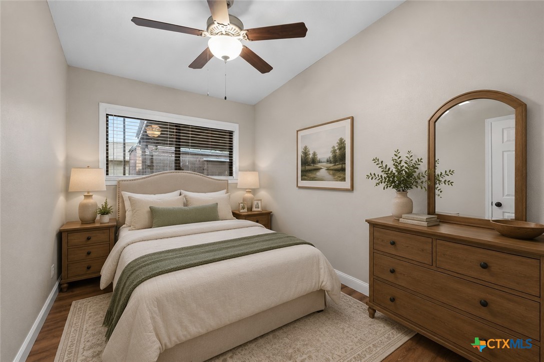 102 Rivercrest Street Luling, TX 78648 - Photo 10 of 36 a bedroom with a large bed and a chandelier