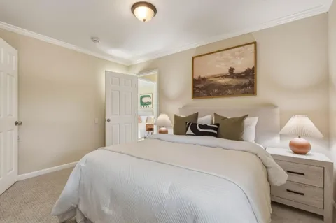 a spacious bedroom with a bed and a window