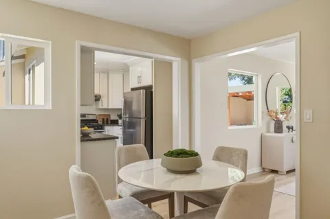a dining room with furniture and window