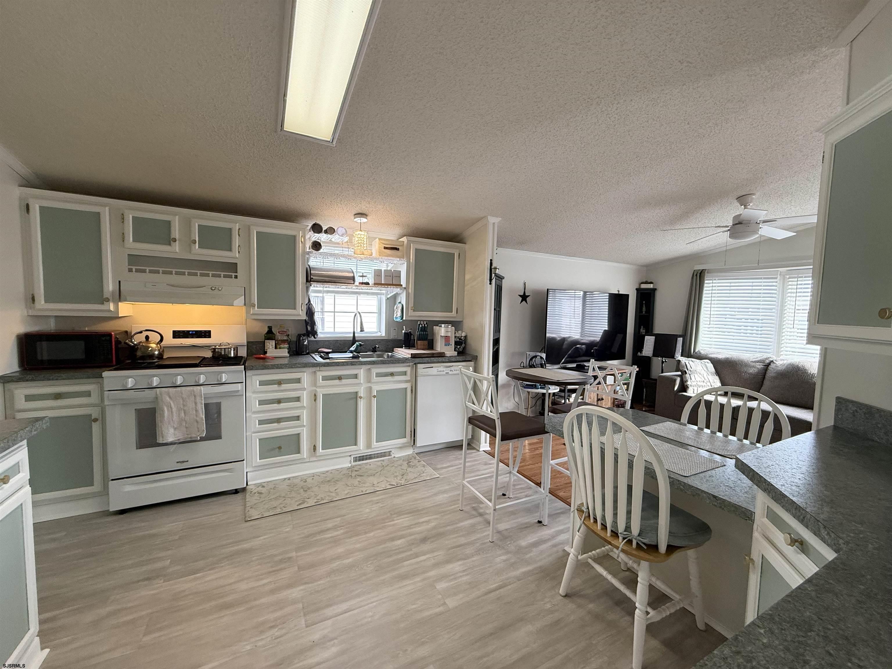 141 Country Lane Buena, NJ 08310 - Photo 7 of 24 a kitchen with white cabinets and appliances