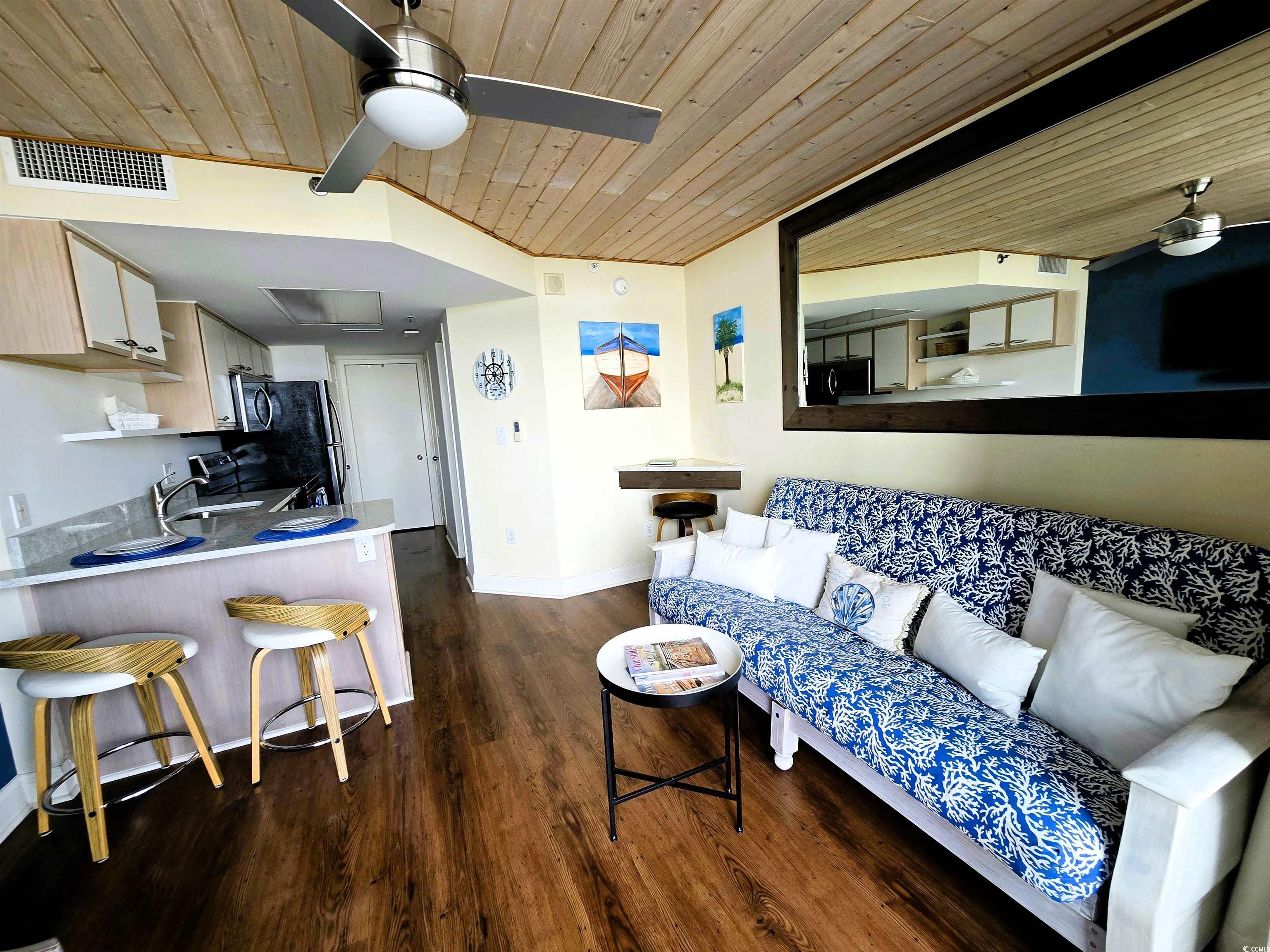 161 Seawatch Drive, Unit 414 Myrtle Beach, SC 29572 - Photo 11 of 15 Living area with wooden ceiling, a ceiling fan, and dark wood-style floors