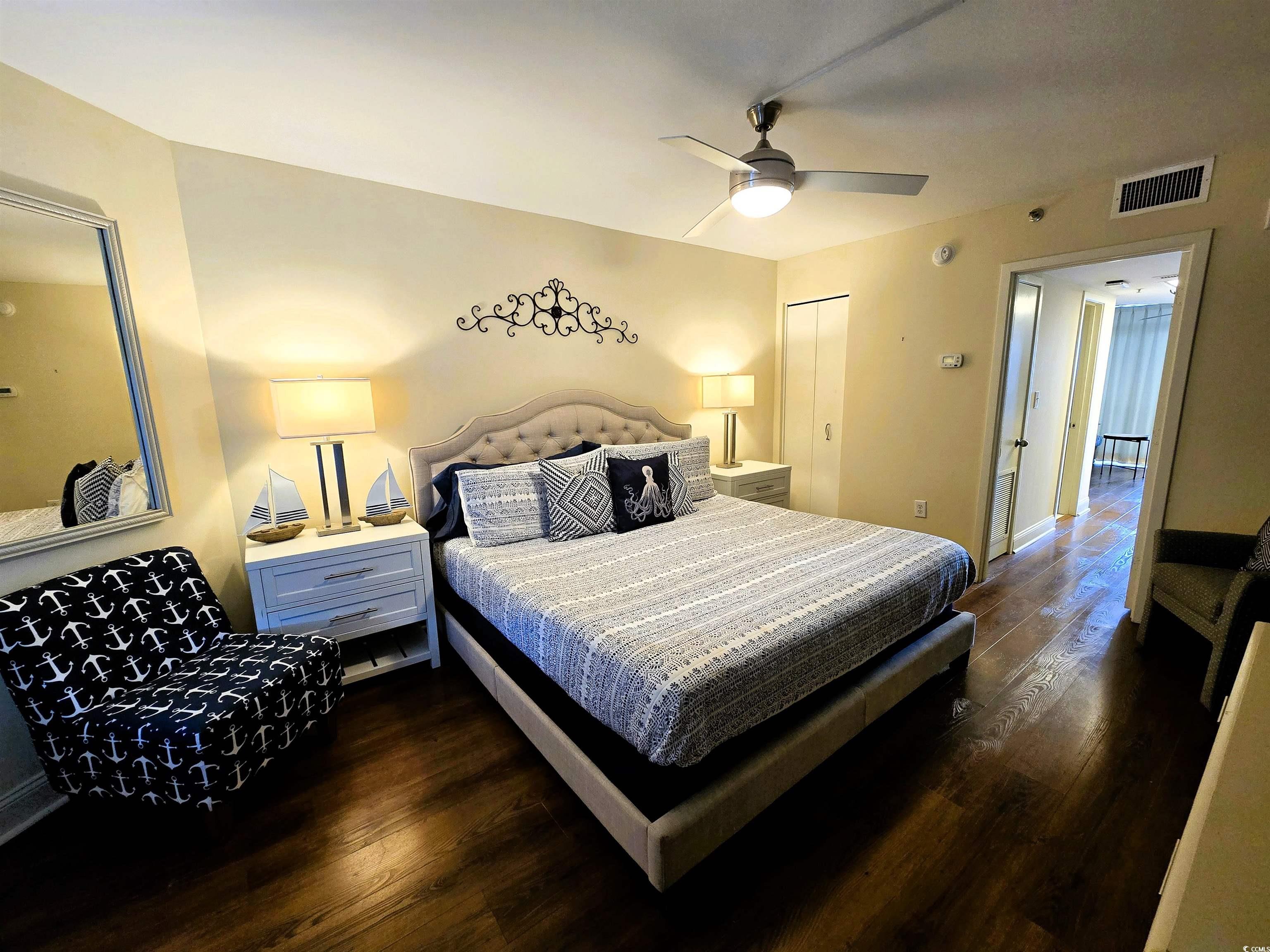 161 Seawatch Drive, Unit 414 Myrtle Beach, SC 29572 - Photo 2 of 15 Bedroom with dark wood finished floors, ceiling fan, and a closet
