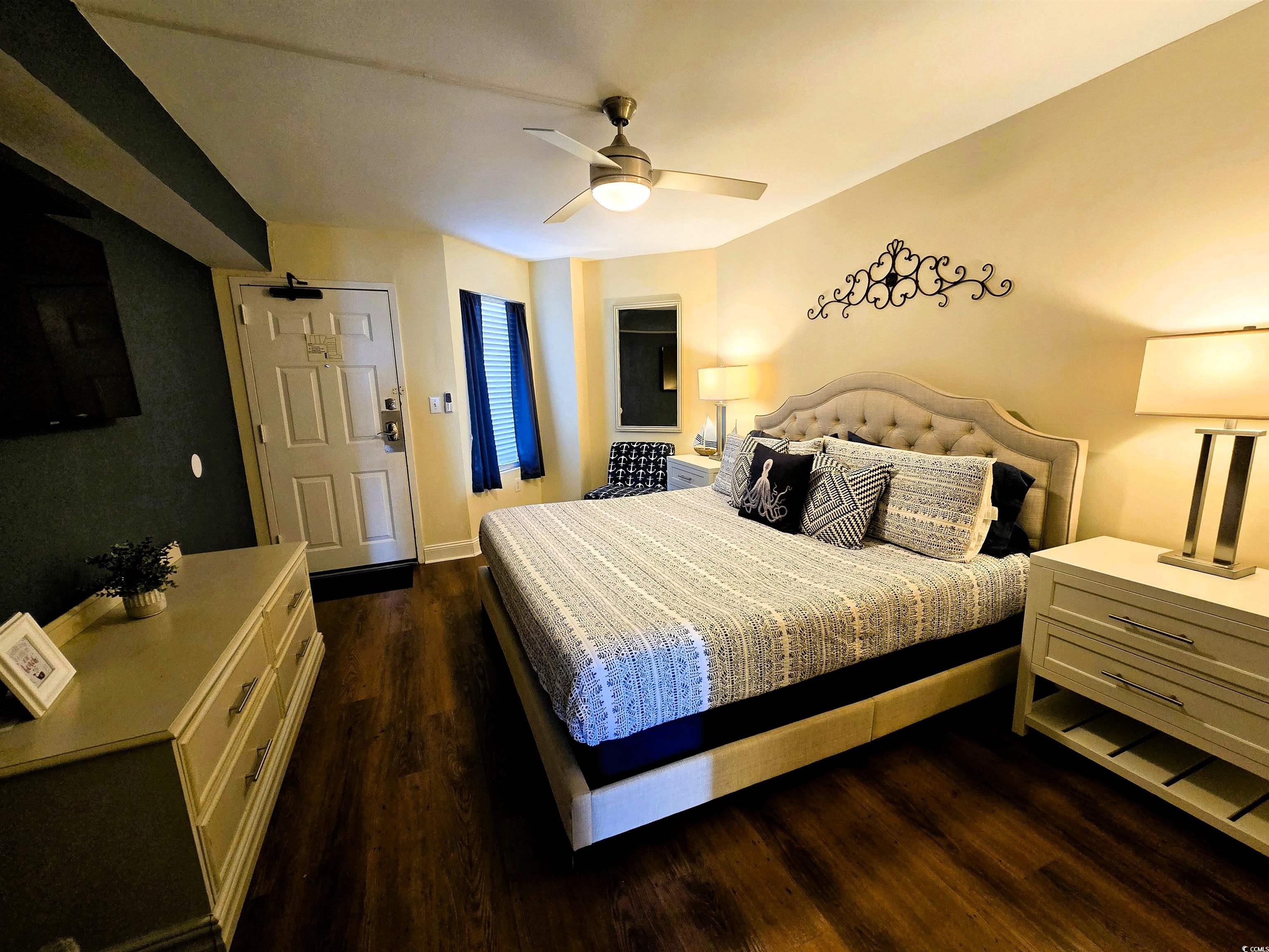 161 Seawatch Drive, Unit 414 Myrtle Beach, SC 29572 - Photo 3 of 15 Bedroom with dark wood-style flooring and ceiling fan