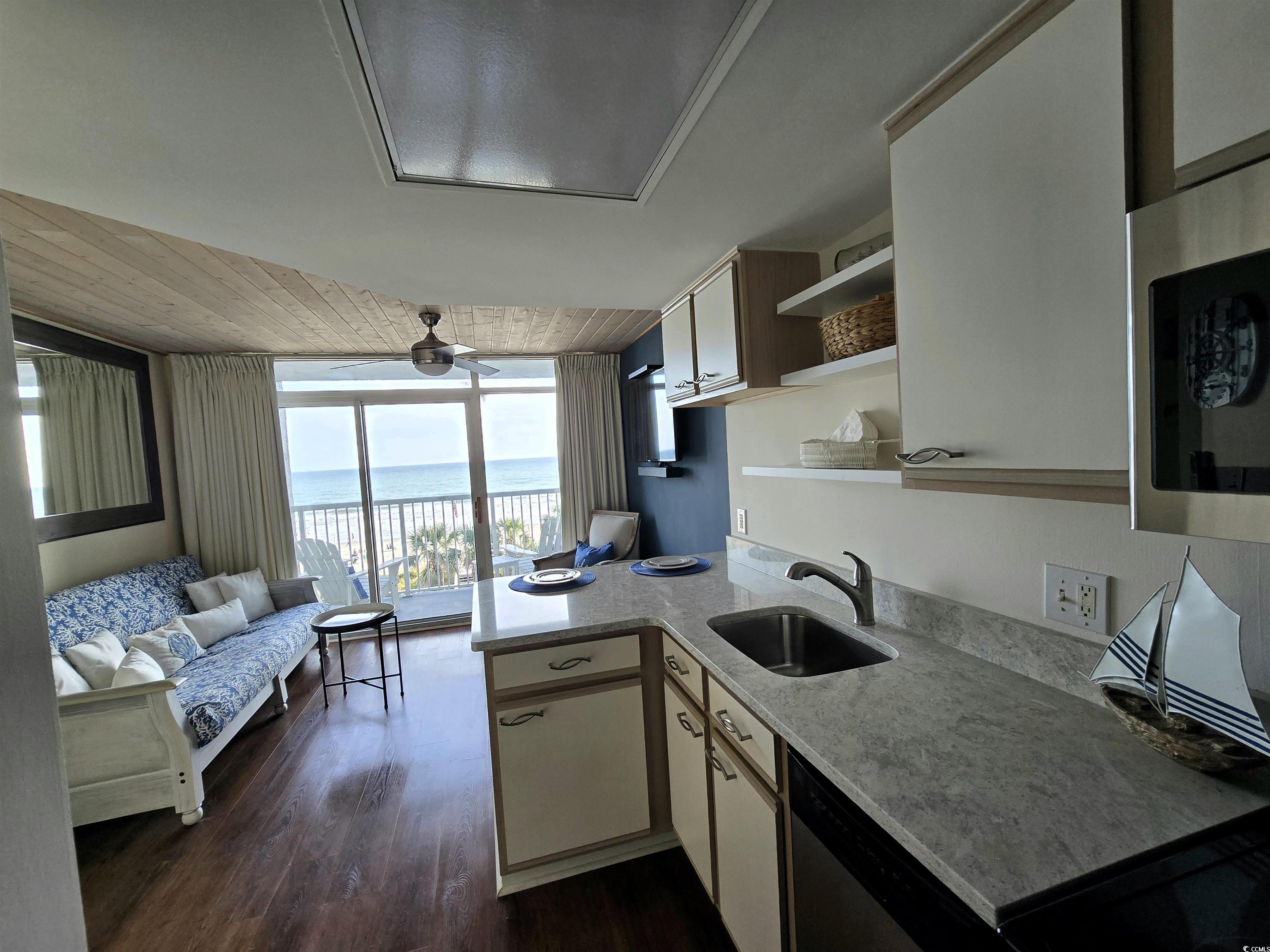 161 Seawatch Drive, Unit 414 Myrtle Beach, SC 29572 - Photo 15 of 15 Kitchen with wooden ceiling, light countertops, open shelves, dark wood-type flooring, and open floor plan