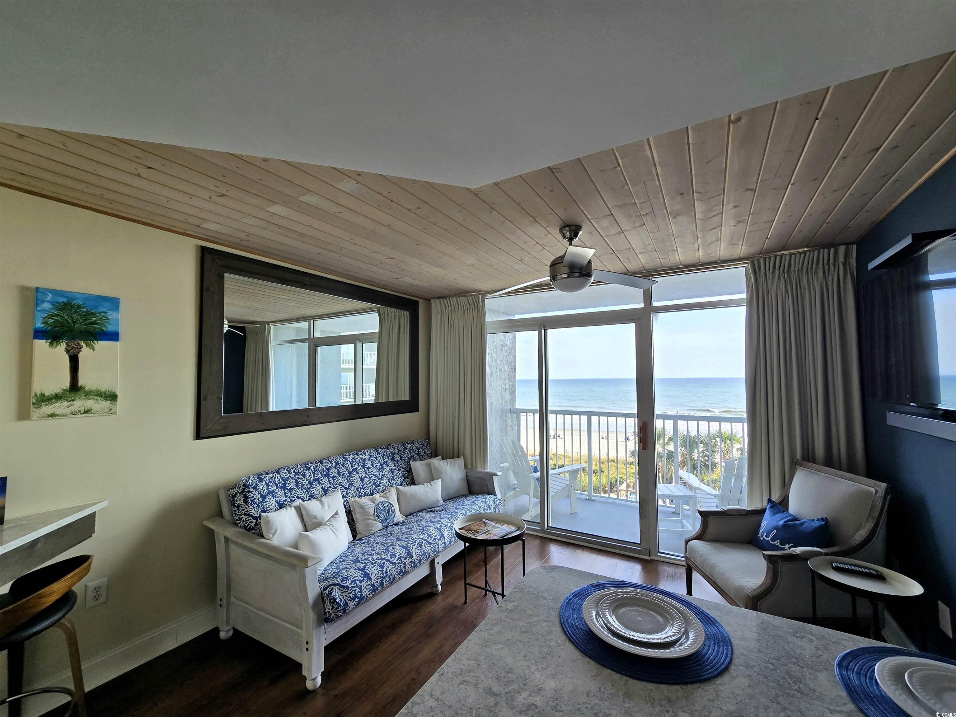 161 Seawatch Drive, Unit 414 Myrtle Beach, SC 29572 - Photo 8 of 15 Sitting room featuring wood ceiling, wood finished floors, expansive windows, and a ceiling fan