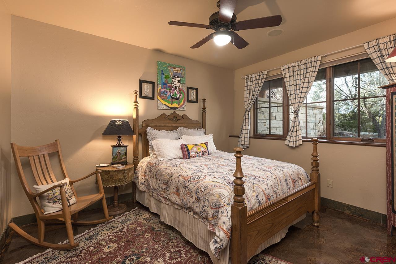 304 Peak Trail Hesperus, CO 81326 - Photo 29 of 35 a bedroom with a bed chairs and a large window