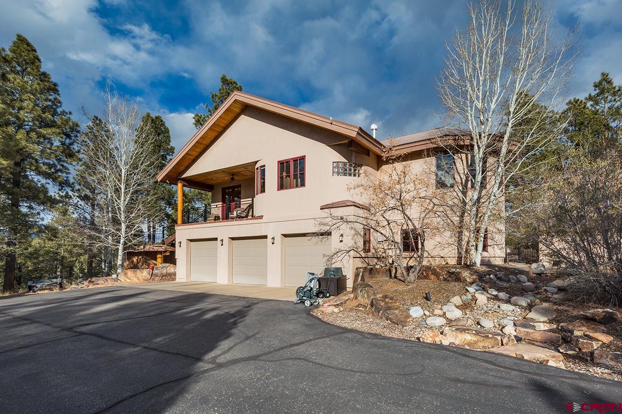 304 Peak Trail Hesperus, CO 81326 - Photo 6 of 35 a view of a white house with a yard and garage