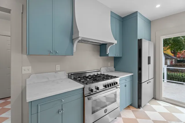 a kitchen with stainless steel appliances granite countertop a sink stove and refrigerator