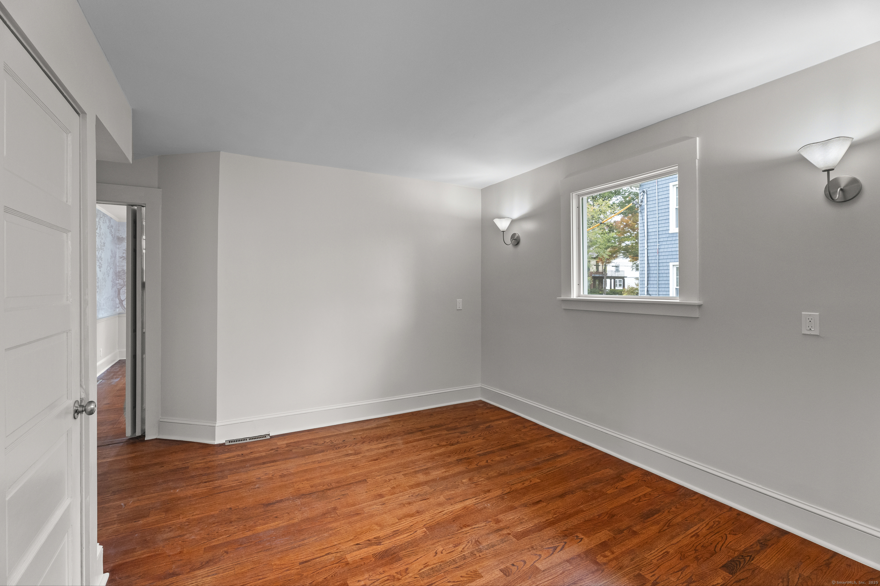119 Westwood Road New Haven, CT 06515 - Photo 18 of 40 a view of empty room with wooden floor and fan