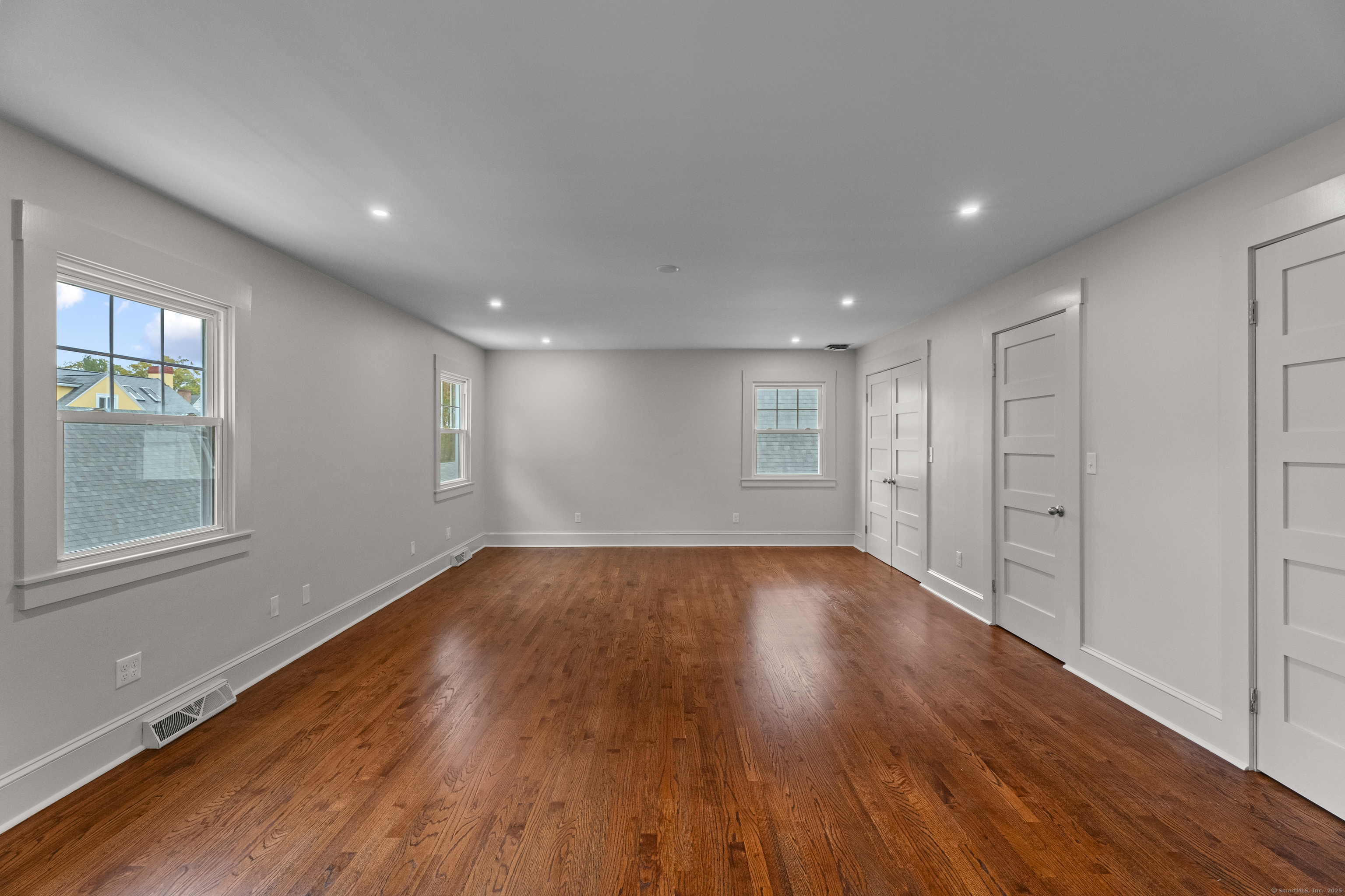 119 Westwood Road New Haven, CT 06515 - Photo 22 of 40 a view of an empty room with wooden floor and a window